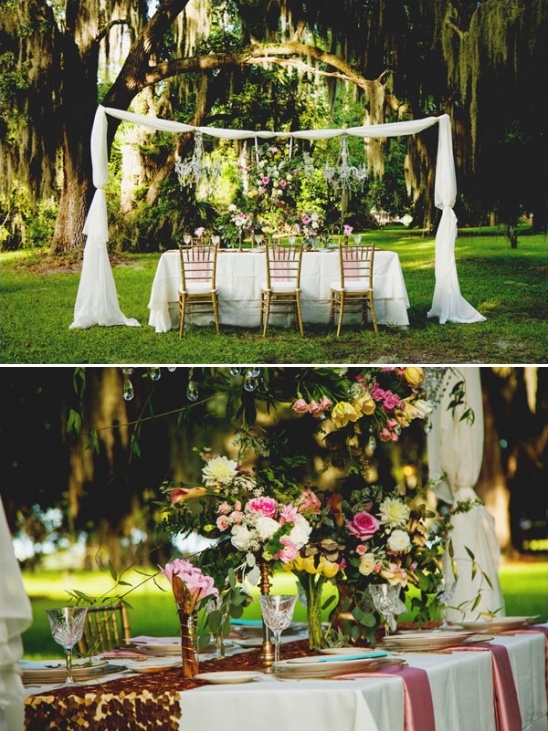 Outdoor wedding reception with flowers and white draping