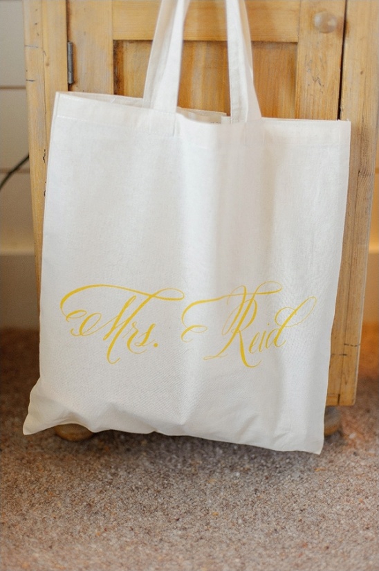 White tote bag with yellow Mrs  Rudd lettering