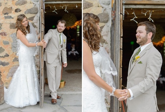 Bride and groom hold hands at rustic wedding entrance