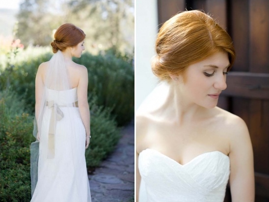 Red-haired bride in a white gown with a veil outdoors