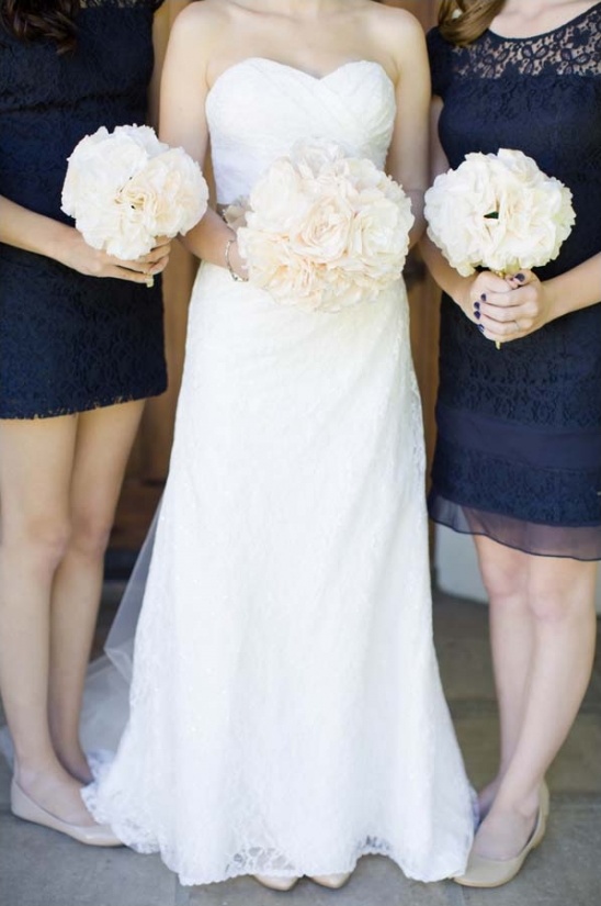 Bride and bridesmaids holding flower bouquets