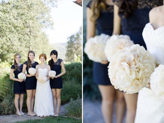 Bride and bridesmaids in navy dresses holding bouquets