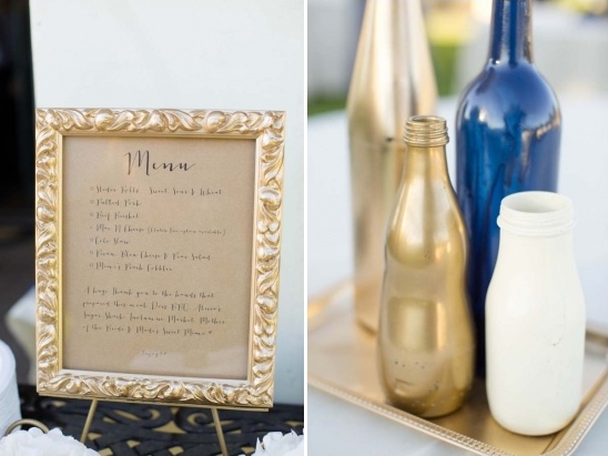 Gold framed wedding menu and painted bottles