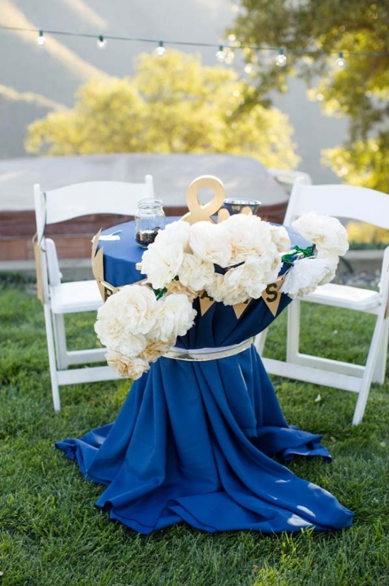 Navy blue table setting with flowers and gold accents