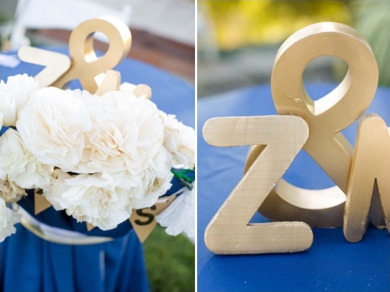 Golden letters and white flowers on blue wedding table