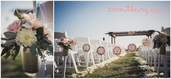 Outdoor wedding aisle decorated with flowers and LOVE sign