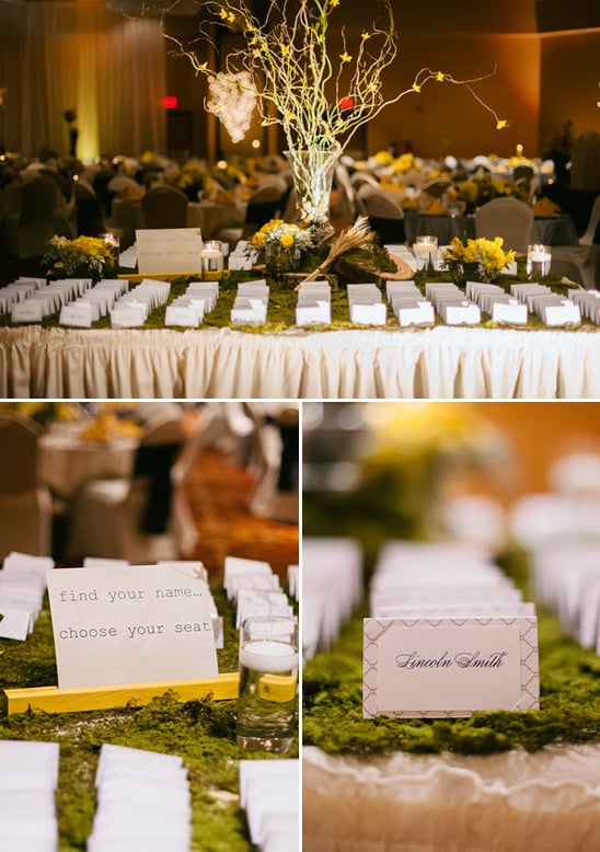 escort card table covered in moss