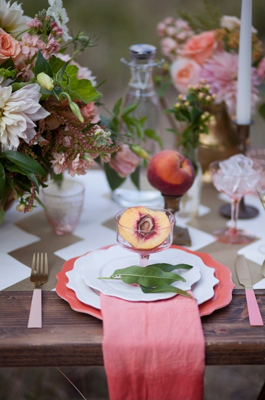 Elegant peach themed wedding table setting with flowers