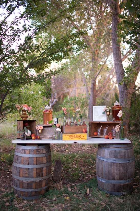 Rustic outdoor bar made with barrels and wooden crates