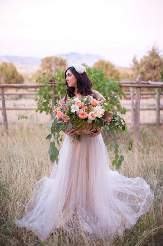Bride in tulle gown with floral bouquet outdoor wedding