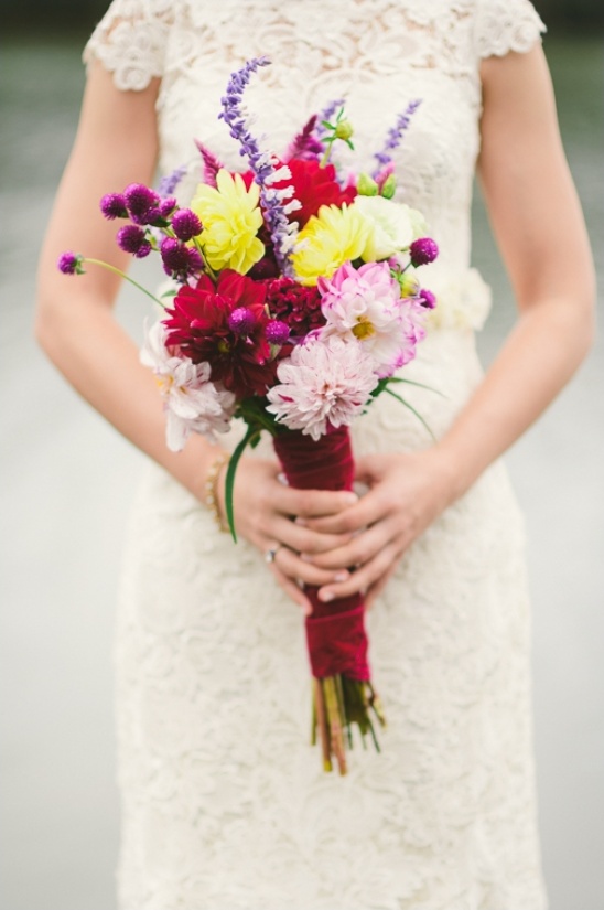 Bride holding vibrant colorful wedding bouquet