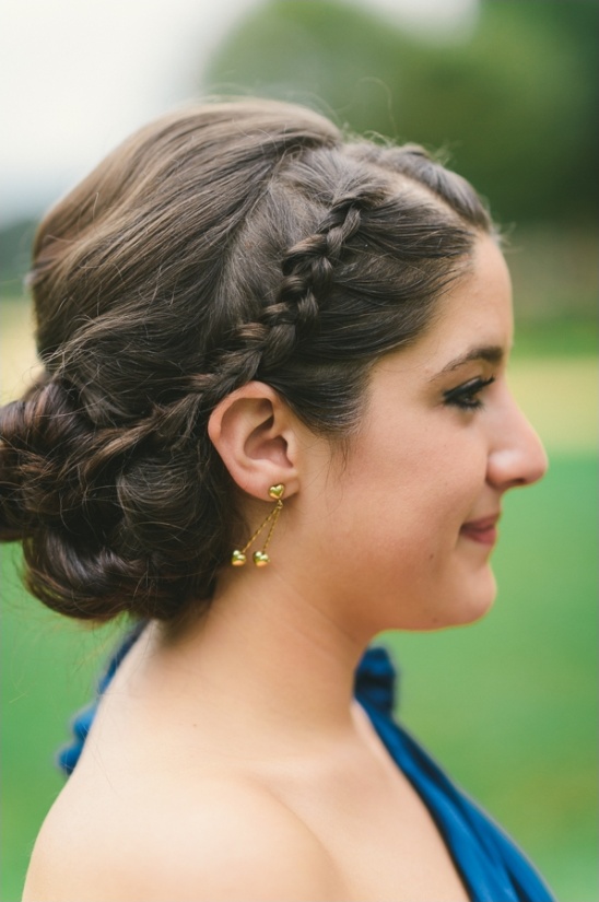 Woman with braided hair and gold earrings