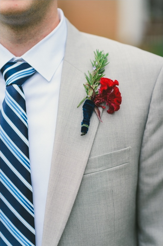 gray suit with blue striped tie and red boutonniere