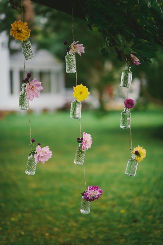Floral arrangements hanging from tree branches
