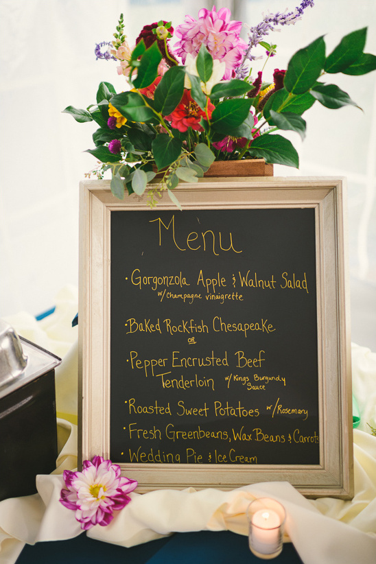 Wedding menu chalkboard with floral arrangement