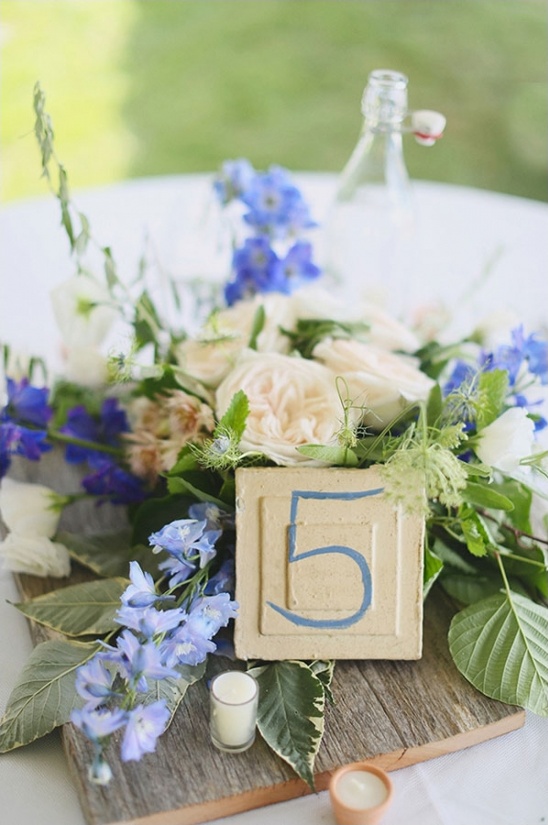 blue and white driftwood themed centerpiece and table number
