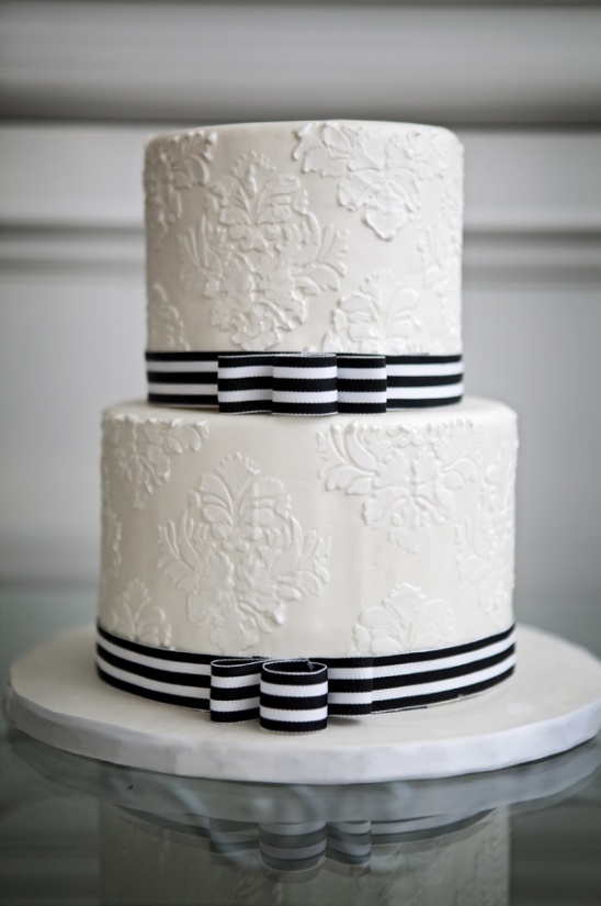 simple white cake with black and white ribbon