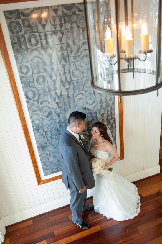 Couple in wedding attire,  standing near art
