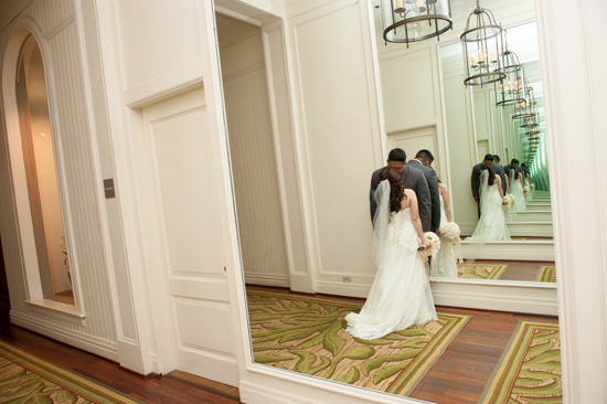 Bride and groom in hallway, wedding reflections