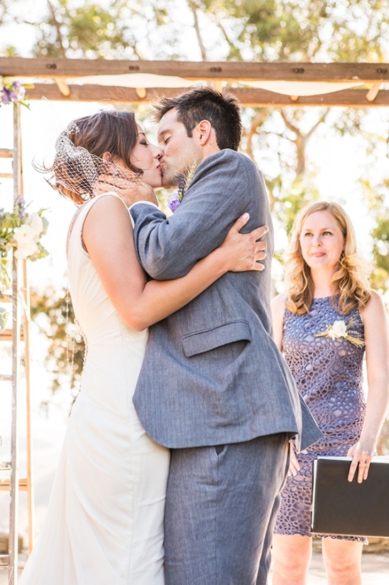 Couple kissing at outdoor wedding ceremony