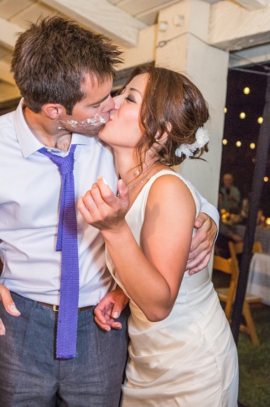 Couple kissing covered in cake frosting