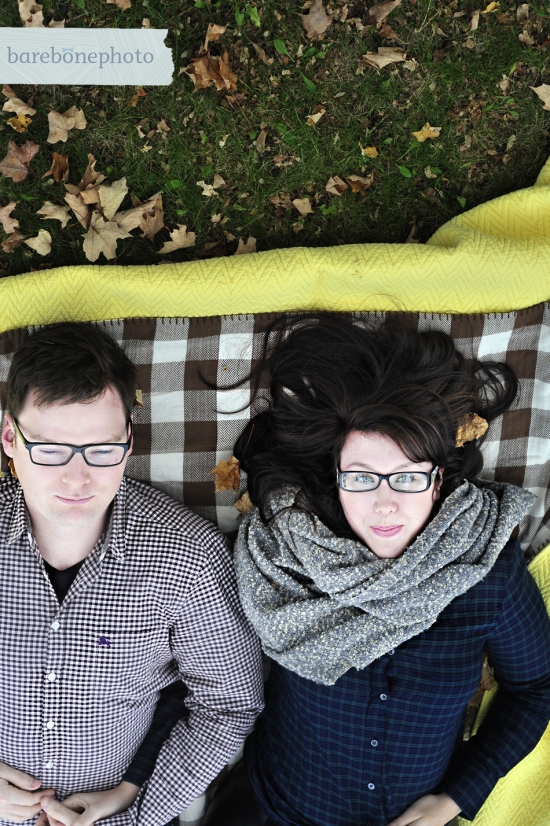 Couple relaxing on checkered blanket