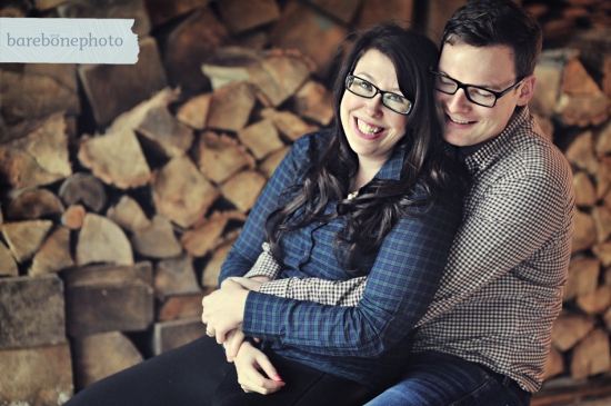 Couple embracing by fireplace