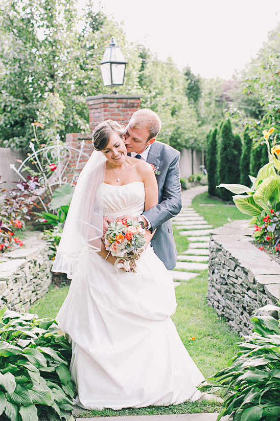 Bride and groom embrace in a beautiful garden wedding