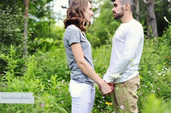 Romantic couple holding hands in a field