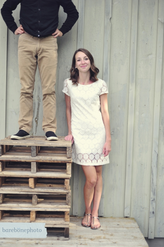 Couple posing playfully on stacked pallets