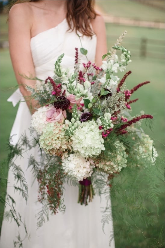 pink white and deep purple cascading bouquet by embellished blooms