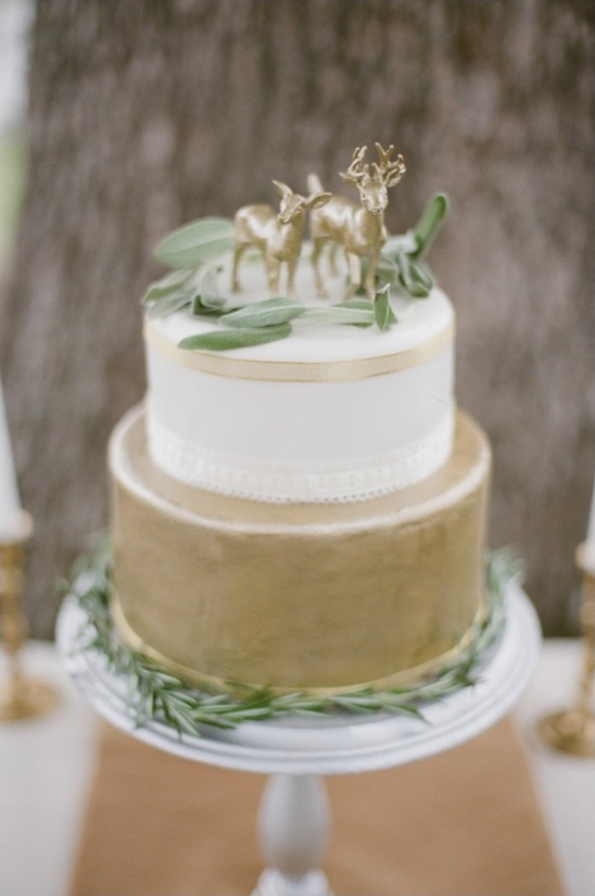 gold and white wedding cake with ribbon accents