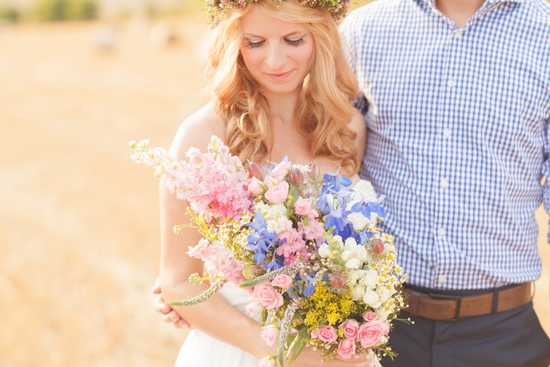 Bride with wildflowers bouquet and groom at wedding
