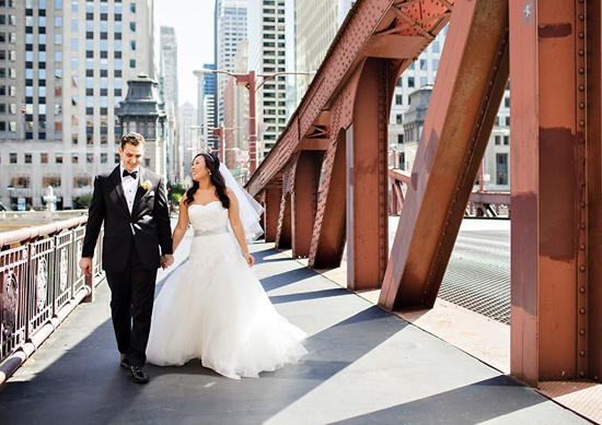 Couple walking city bridge wedding day