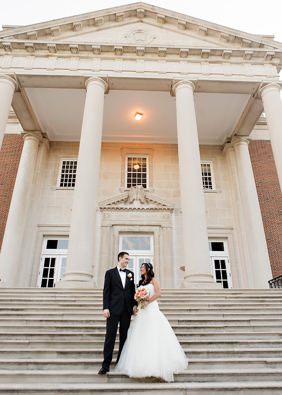 Bride and groom on steps of colonnaded building