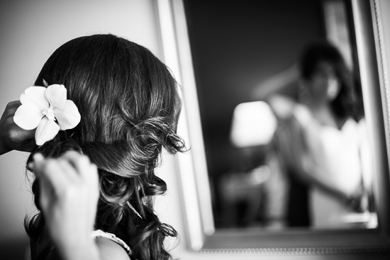Bride getting hair styled with flower