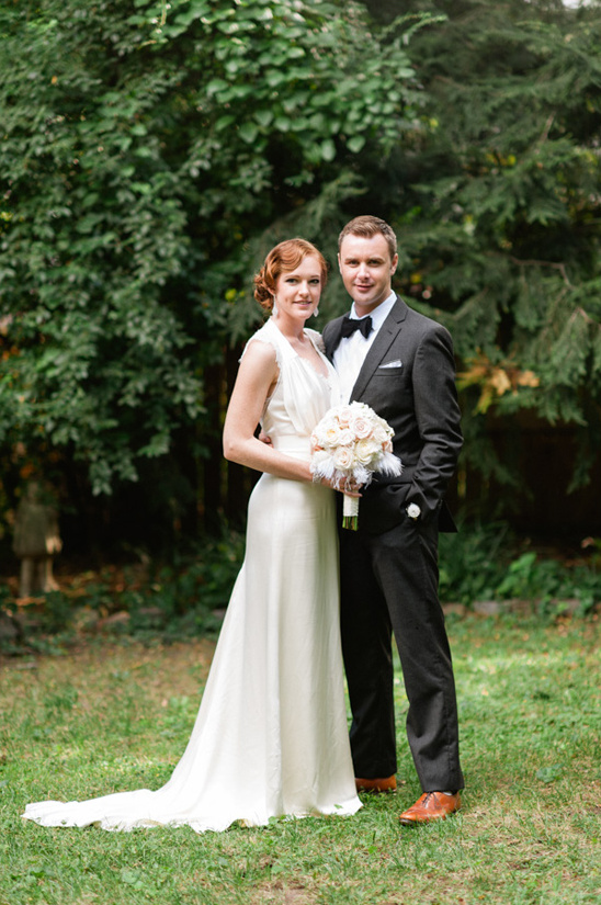 Happy bride and groom posing outdoors for wedding photo