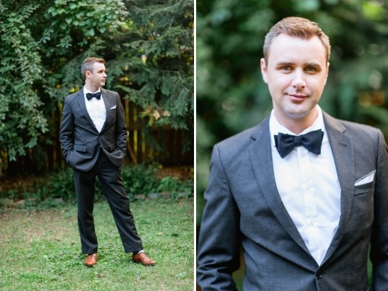 Groom in stylish dark gray suit and bow tie