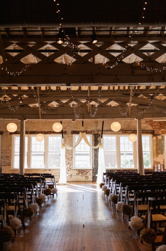 Rustic wedding ceremony aisle,  string lights, and draped fabric