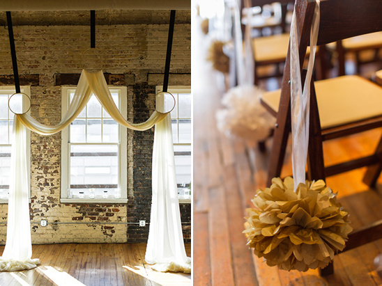 Elegant wedding ceremony decor with flowing fabric and gold pom-poms