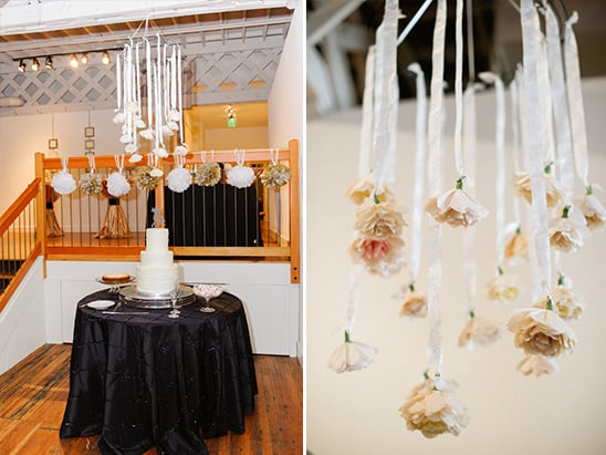 hanging paper flower decoration over cake table