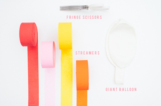 Colorful streamers fringe scissors and a balloon for party