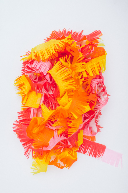 Colorful fringed paper in yellow orange and red tones