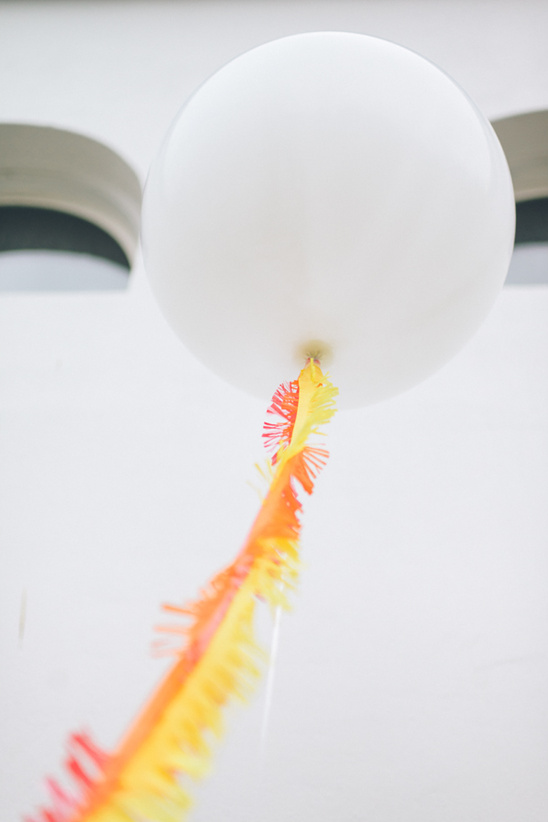 White balloon with orange and yellow streamers party