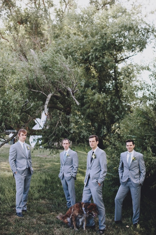Groomsmen in gray suits with dog outdoor wedding