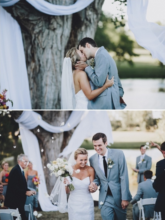 Bride and groom share a kiss after their outdoor wedding