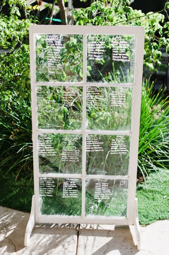 Wedding seating chart displayed on a repurposed window pane