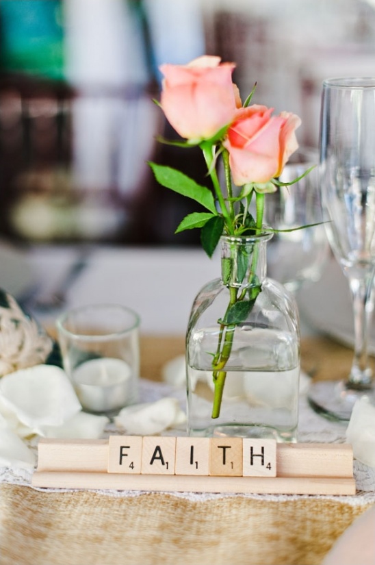 Peach roses and Faith tiles on a wedding table decor