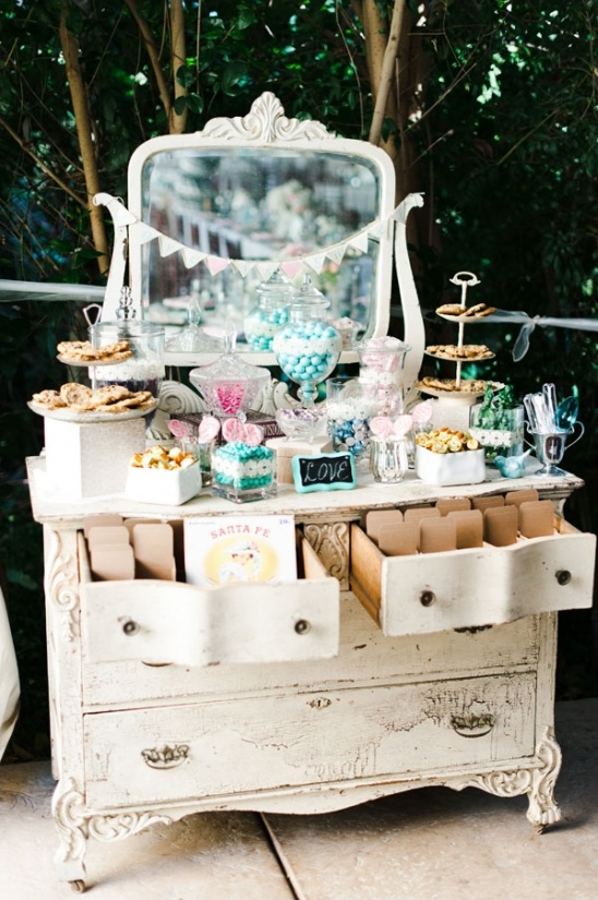 Vintage dresser with mirror display of sweets and favors