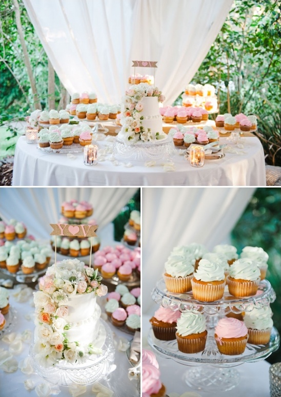 Wedding cake and cupcake display with pastel frosting